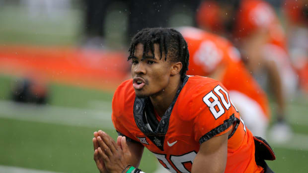 Oklahoma State Cowboys wide receiver Brennan Presley (80) stretches before a college football game between Oklahoma State and West Virginia at Boone Pickens Stadium in Stillwater, Okla., Saturday, Nov. 26, 2022.